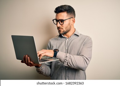 Young business man wearing glasses working using computer laptop with a confident expression on smart face thinking serious - Shutterstock ID 1682392363