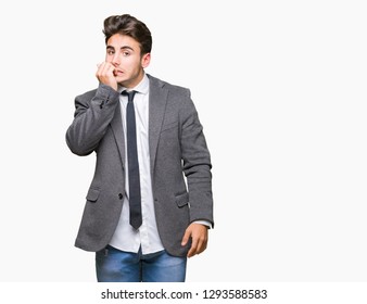 Young business man wearing suit and tie over isolated background looking stressed and nervous with hands on mouth biting nails. Anxiety problem.