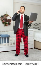 Young Business Man Work From Home During Coronavirus Pandemic Quarantine. Handsome Man In Suit And Pajama Pant Working From Home Office. Freelance Work. Working Online. 