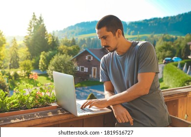 Young business man working with laptop on beautiful scenic mountain background. Business man working near swimming pool in a rural hotel. Freelancer. Traveler.  - Shutterstock ID 1819516727
