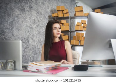 Young business owner as online freelancer checking the box and check the customer list. - Shutterstock ID 1015216735