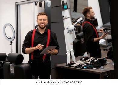 Young Business Owner With Tablet In Barber Shop