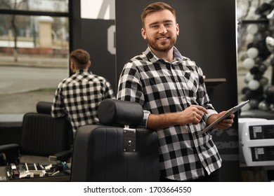 Young Business Owner With Tablet In Barber Shop