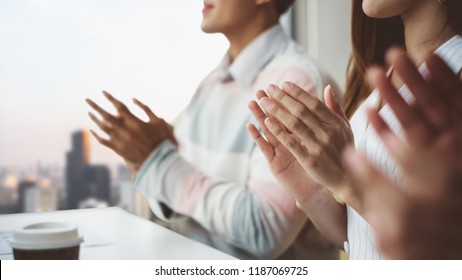 Young business people clapping hands during meeting in office for their success in business work - Powered by Shutterstock