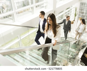 Young Business People Climb The Stairs In The Office Building