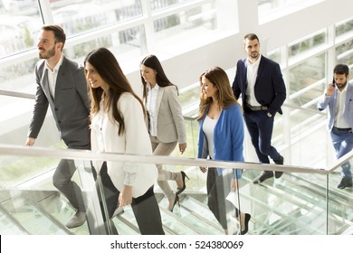 Young Business People Climb The Stairs In The Office Building