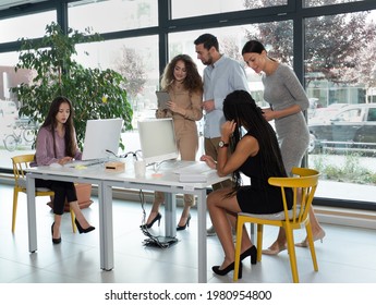 Young Business People In Discussion, Mixed Race. Creative Team Meeting In Modern Work Space. We Are Stronger Together. Female Chef. An Empowered Workplace.