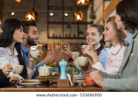 Young Business People Group Drink Coffee Sitting Cafe Table, Friends Hold Cup Smiling Mix Race Men Women Talking