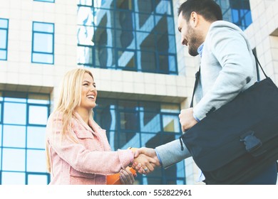 Young Business People Having Meeting Outside Of Company Building.