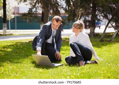 Young business people with laptop - Powered by Shutterstock