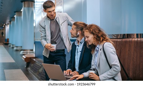 Young Business People With A Laptop On The Subway Platform.