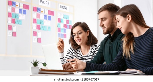 Young business people with laptop working in office. Agile concept - Shutterstock ID 2185767017