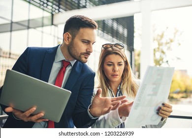 Young business people are relaxing in front of the company building and discussing about new project. - Shutterstock ID 1203226939