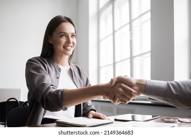 Young business people shaking hands in the office. Handshake, finishing successful meeting. Business etiquette, congratulation, meeting, job interview, new business, startup, employee, teamwork, trust