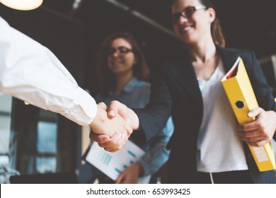 Young Business People Shaking Hands In The Office. Successful Negotiations. Three Persons