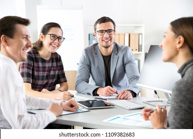 Young business people are sitting around the table at a meeting in the office - Shutterstock ID 1109382683