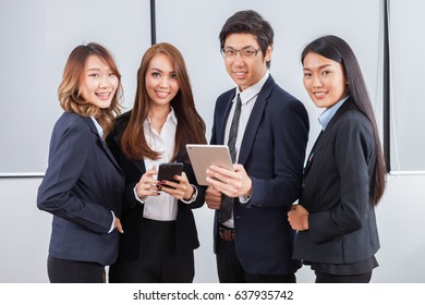 Young Business People Is Standing Concentrate On IPad And Smile With White Background