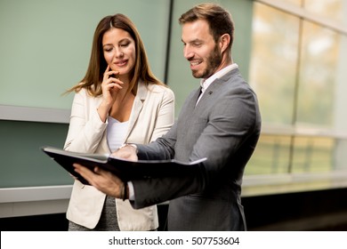 Young Business People Talking And Viewing Documents Outdoor