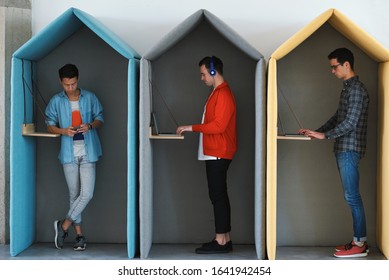 Young Business People Working In Colorful Office Cubicles In Workplace