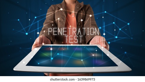 Young business person working on tablet and shows the digital sign: PENETRATION TEST