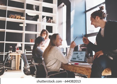 Young Business Team Working Together In Bright Loft Space. Marketing Group Discussing New Product Plan. New Startup Company