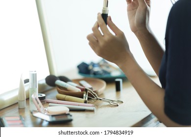 Young business woman applying make-up - Powered by Shutterstock