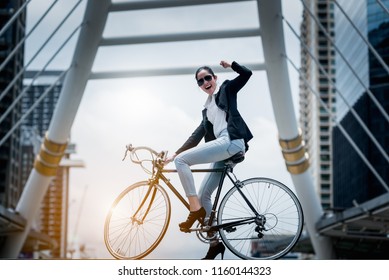 Young business woman with bike for healthy and ecology concept. business woman standing with bike lifestyle confident successful  city building background.  
