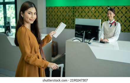 Young  Business Woman At Check-in Counter With Airlines Staff. Airline Transportation And Tourism Concept.