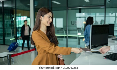 Young  Business Woman At Check-in Counter With Airlines Staff. Airline Transportation And Tourism Concept.