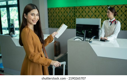 Young  Business Woman At Check-in Counter With Airlines Staff. Airline Transportation And Tourism Concept.