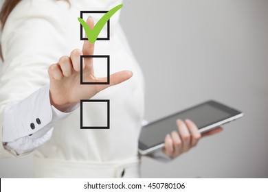 Young Business Woman Checking On Checklist Box. Gray Background.