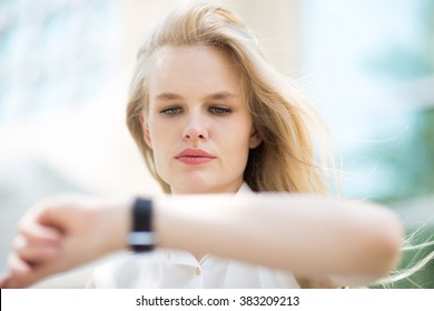 Young Business Woman Checking The Time On Her Watch.