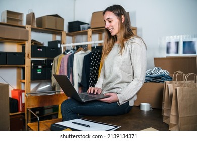 Young business woman checks orders on her online clothing store on laptop - Millennials write an email for customer service after shopping of his clients - Concept of new home business - Shutterstock ID 2139134371