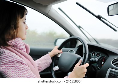 Young Business Woman Driving Car In Rain (focus On Face)