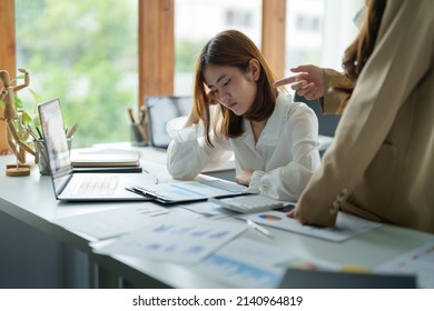 Young Business Woman Feeling Be Serious, Holding Her Head While Her Boss Is Complaining About The Work.