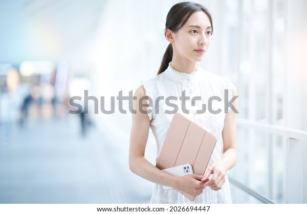 Young business woman or female college student by\
the window