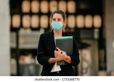 Young Business Woman Going To Work Down The Street Wearing Medical Mask