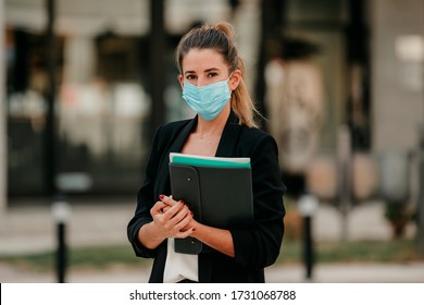 Young Business Woman Going To Work Down The Street Wearing Medical Mask