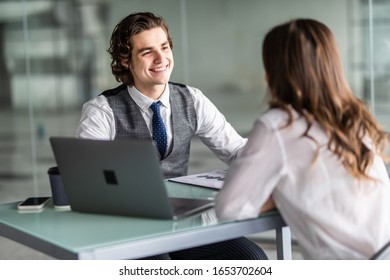 Young business woman and handsome man have meeting in the office - Shutterstock ID 1653702604
