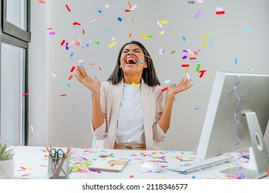 Young business woman having fun time catching confetti - Shutterstock ID 2118346577