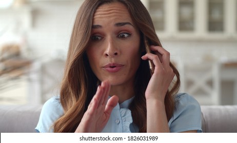 Young Business Woman Having Unpleasant Conversation On Mobile Phone At Home Office. Portrait Of Upset Woman Talking On Cellphone On Sofa.