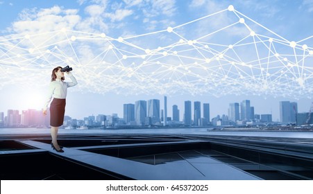 young business woman looking through field glasses and mesh communication network concept. IoT(Internet of Things). ICT(Information Communication Network). Smart city. network monitoring.