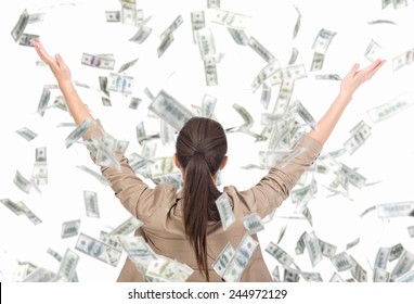 Young business woman and money banknotes flying in air on the white background.