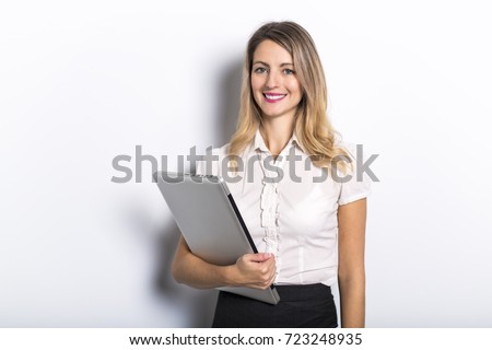 Young business woman offers computer product, on grey background
