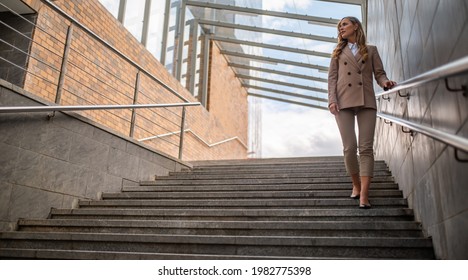 Young Business Woman On Subway Stairs