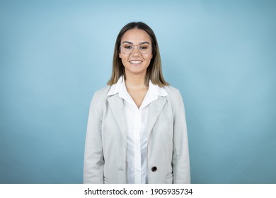 Young Business Woman Over Isolated Blue Background With A Happy Face Standing And Smiling With A Confident Smile Showing Teeth