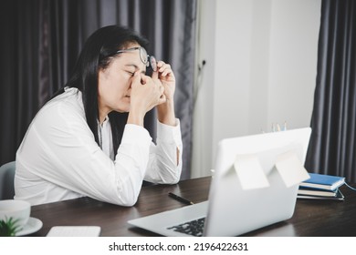 Young Business Woman Person Sleepy And Has Frustration Eye Problems With Cephalalgia Disease From Using Laptop Computer On Her Office Desk. Stressed Female Employee Tired And Exhausted From Overwork.