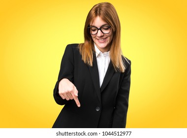 Young Business Woman Pointing Down On Colorful Background