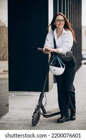 Young Business Woman Riding Electro Scooter By Ofice Center