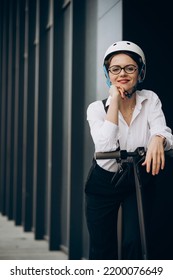 Young Business Woman Riding Electro Scooter By Ofice Center